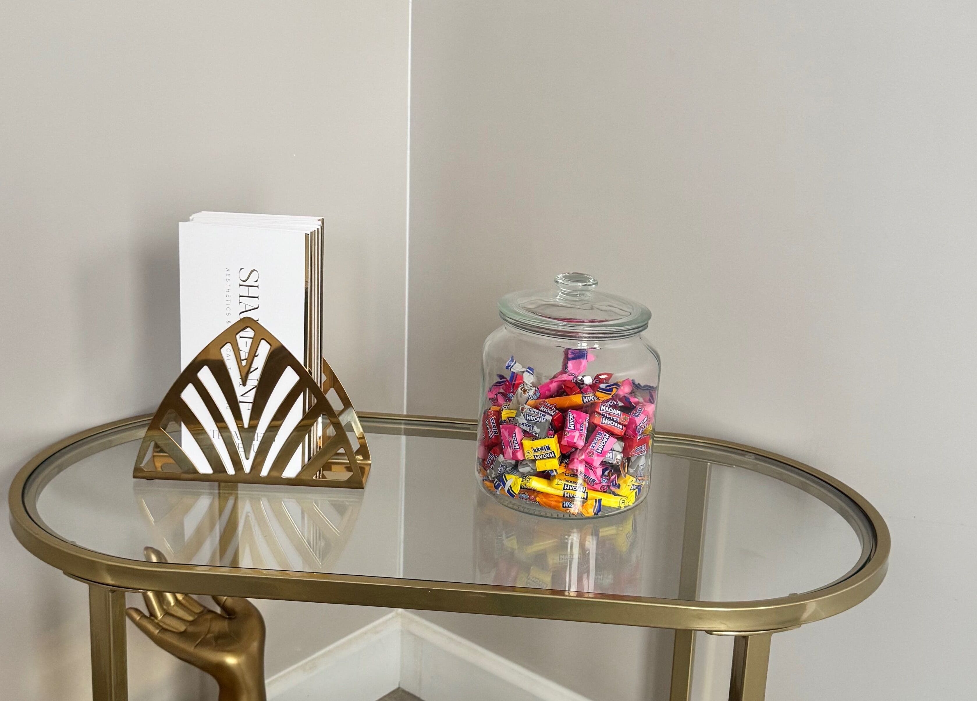 Welcome table at Shani-Anne Aesthetics and Medical Tattooing, Hornchurch, England, GB with candy jar and decor.