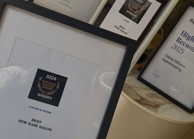 Award certificates displayed at Olivia Wilson Hairdressing in Falkirk, Scotland, GB, highlighting achievements.