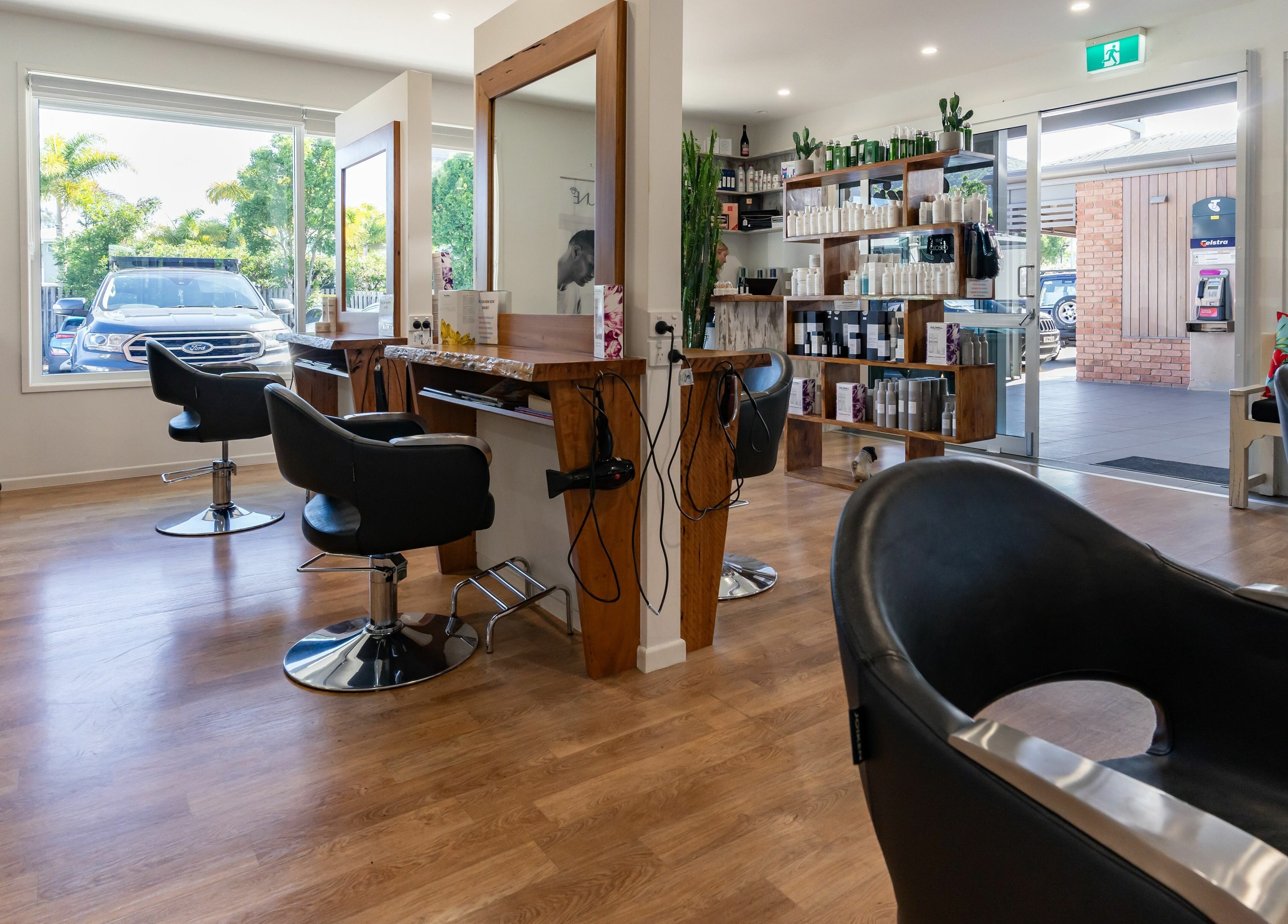 Interior view of Rock Paper Scissors Hair and Beauty salon in Mount Coolum, Queensland, AU, showcasing modern styling chairs.