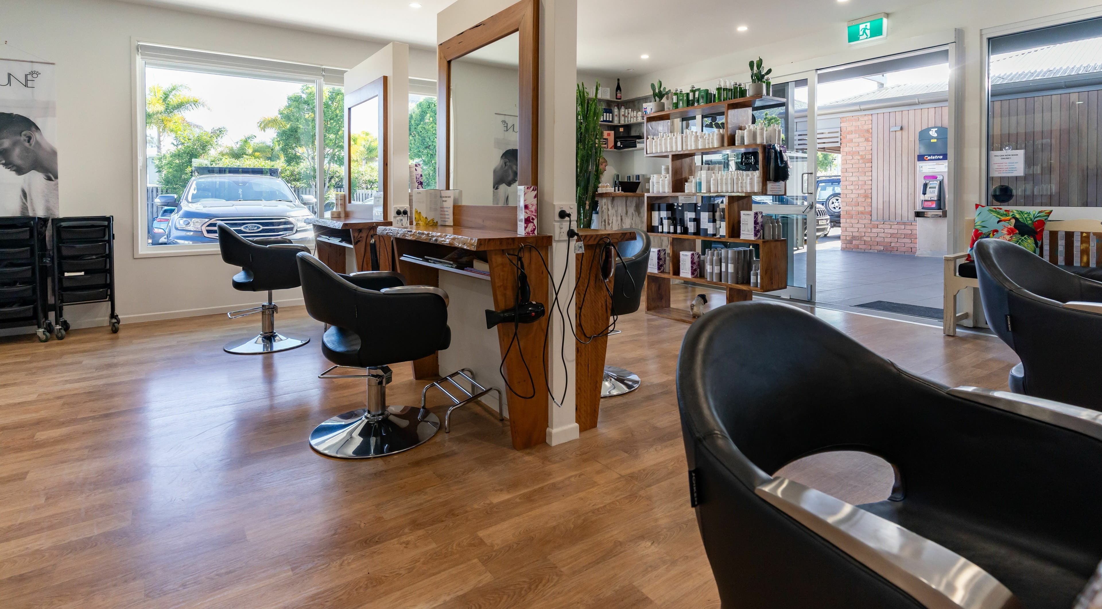 Interior view of Rock Paper Scissors Hair and Beauty salon in Mount Coolum, Queensland, AU, showcasing modern styling chairs.