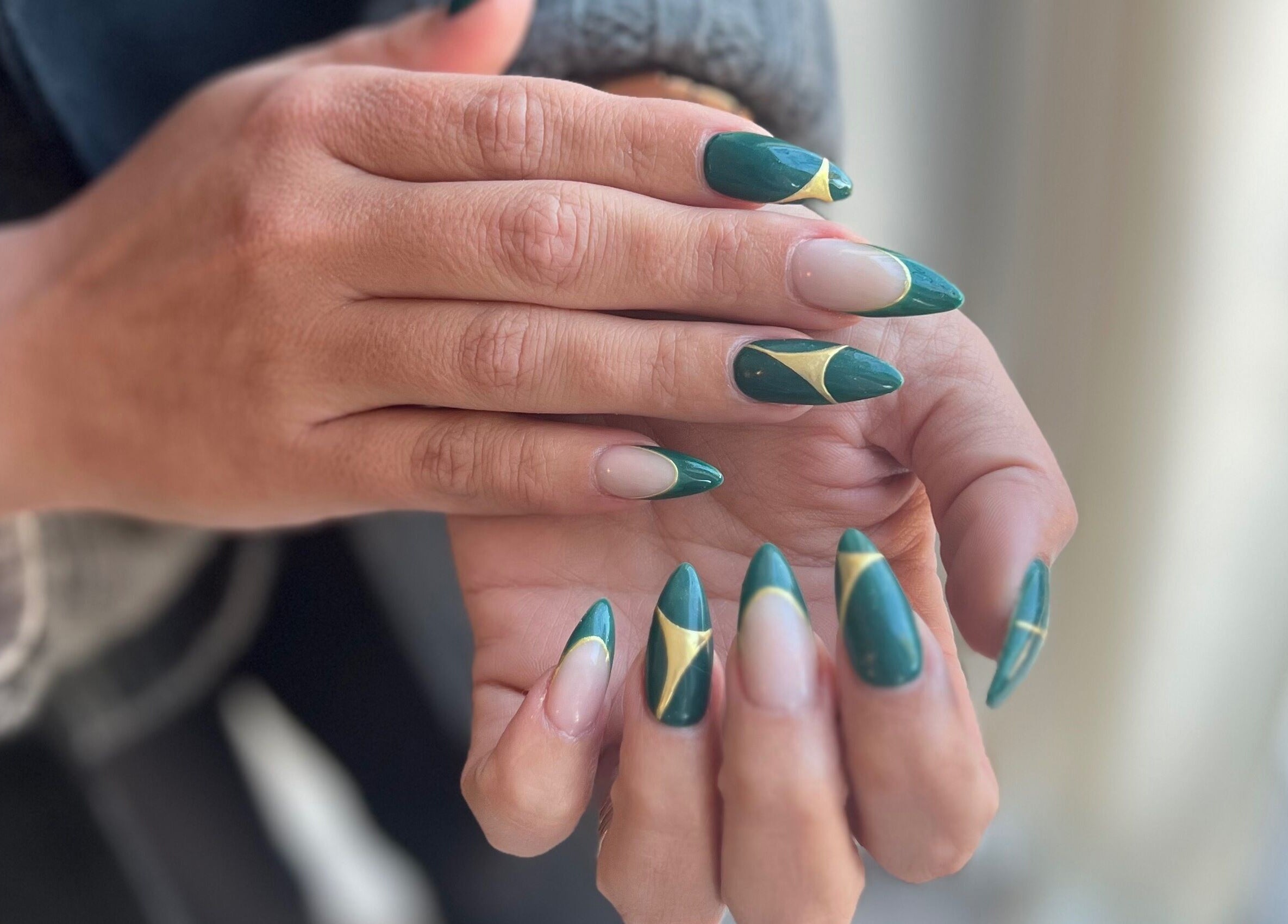 Elegant nail art at Beauty by Design, Gqeberha, Eastern Cape, ZA with green and gold geometric designs.