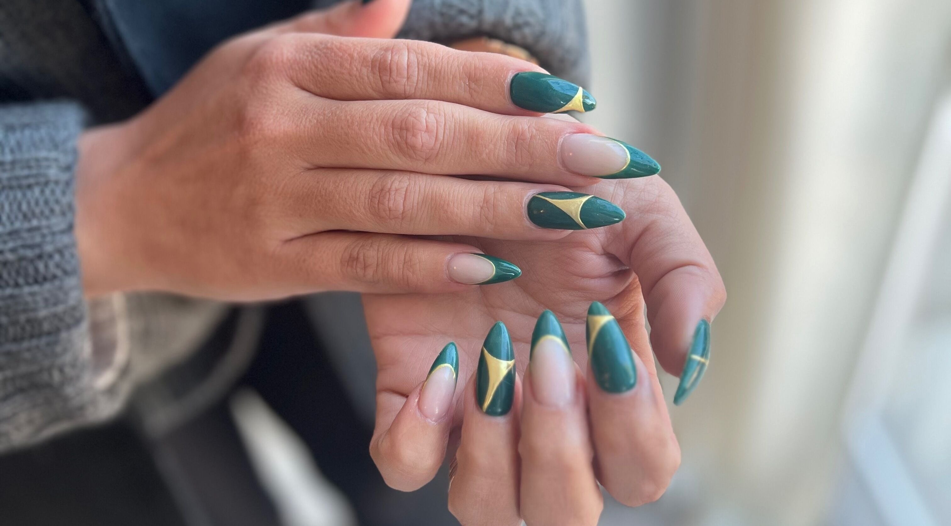 Elegant nail art at Beauty by Design, Gqeberha, Eastern Cape, ZA with green and gold geometric designs.