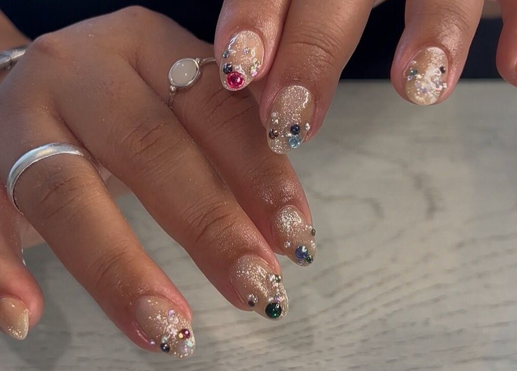 Sparkling nail art with gems at Beauty by Design, Gqeberha, Eastern Cape, ZA offering intricate hand designs.