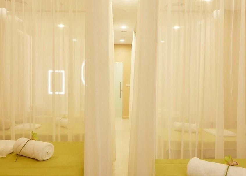 Tranquil massage beds at The ZUU Ladies Massage Spa Lounge | Home Service, Dubai, AE with elegant sheer curtains.
