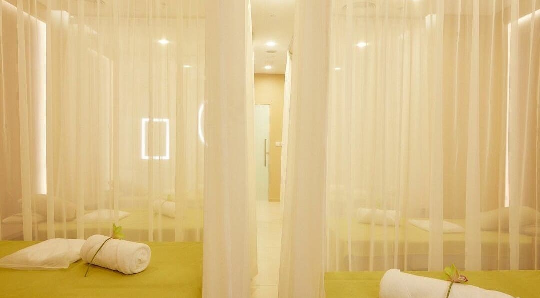 Tranquil massage beds at The ZUU Ladies Massage Spa Lounge | Home Service, Dubai, AE with elegant sheer curtains.