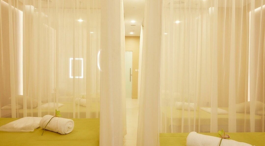 Tranquil massage beds at The ZUU Ladies Massage Spa Lounge | Home Service, Dubai, AE with elegant sheer curtains.