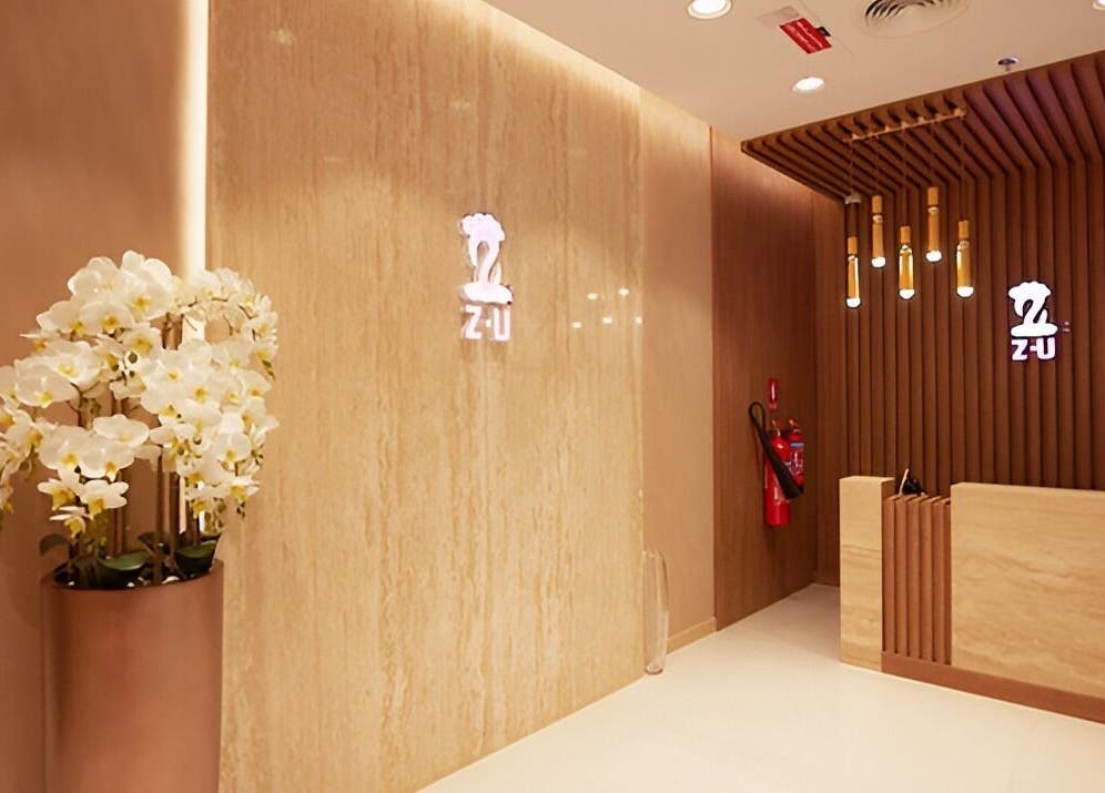 Elegant reception area at The ZUU Ladies Massage Spa Lounge, Dubai, Dubai, AE with floral decor and warm lighting.