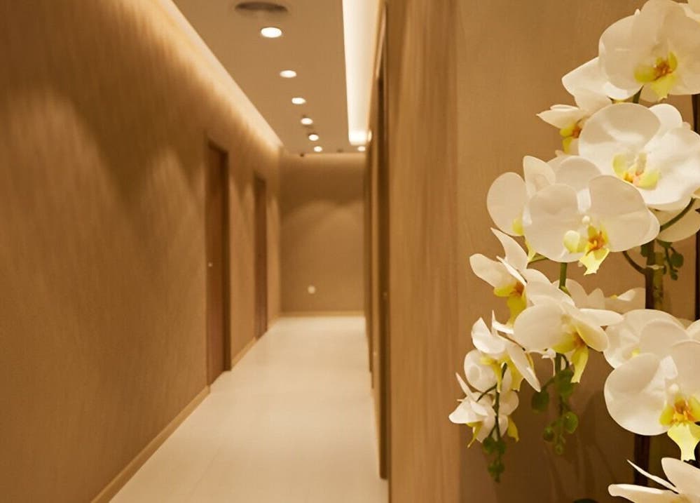 Elegant orchids decorate a soothing corridor at The ZUU Ladies Massage Spa Lounge, Dubai, Dubai, AE.