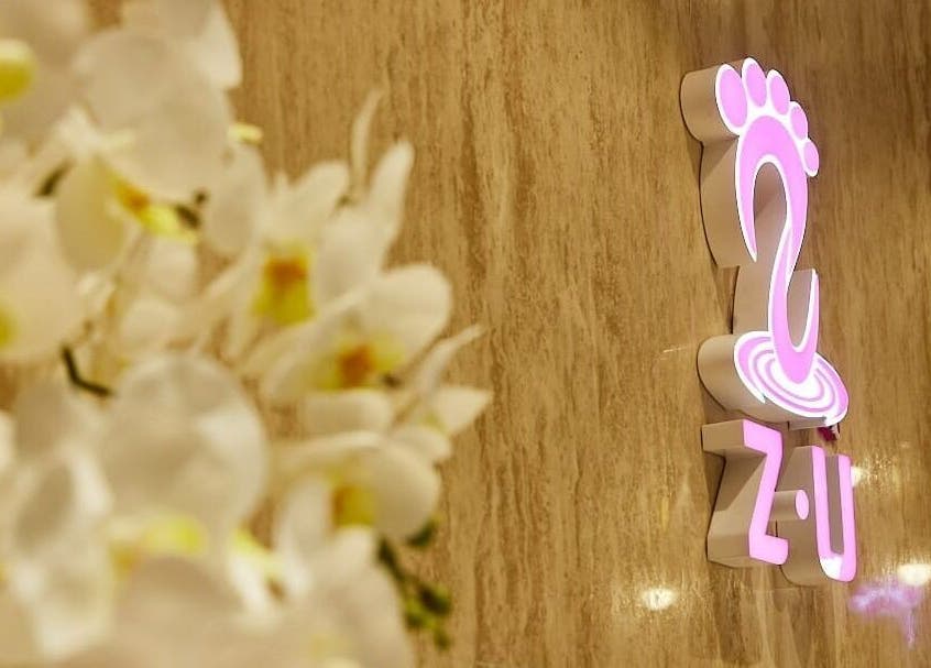 Logo of The ZUU Ladies Massage Spa Lounge, Dubai, Dubai, AE, with orchids in the foreground.