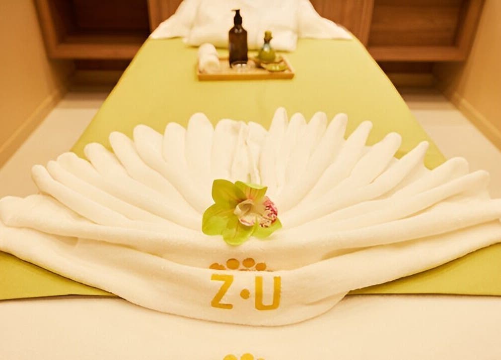 Luxurious massage table set up at The ZUU Ladies Massage Spa Lounge, Dubai, Dubai, AE, with elegant towel decor.