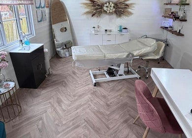 Relaxing treatment room at Netti's Beauty Bar in Telford, England, GB, featuring modern decor and a comfortable massage table.