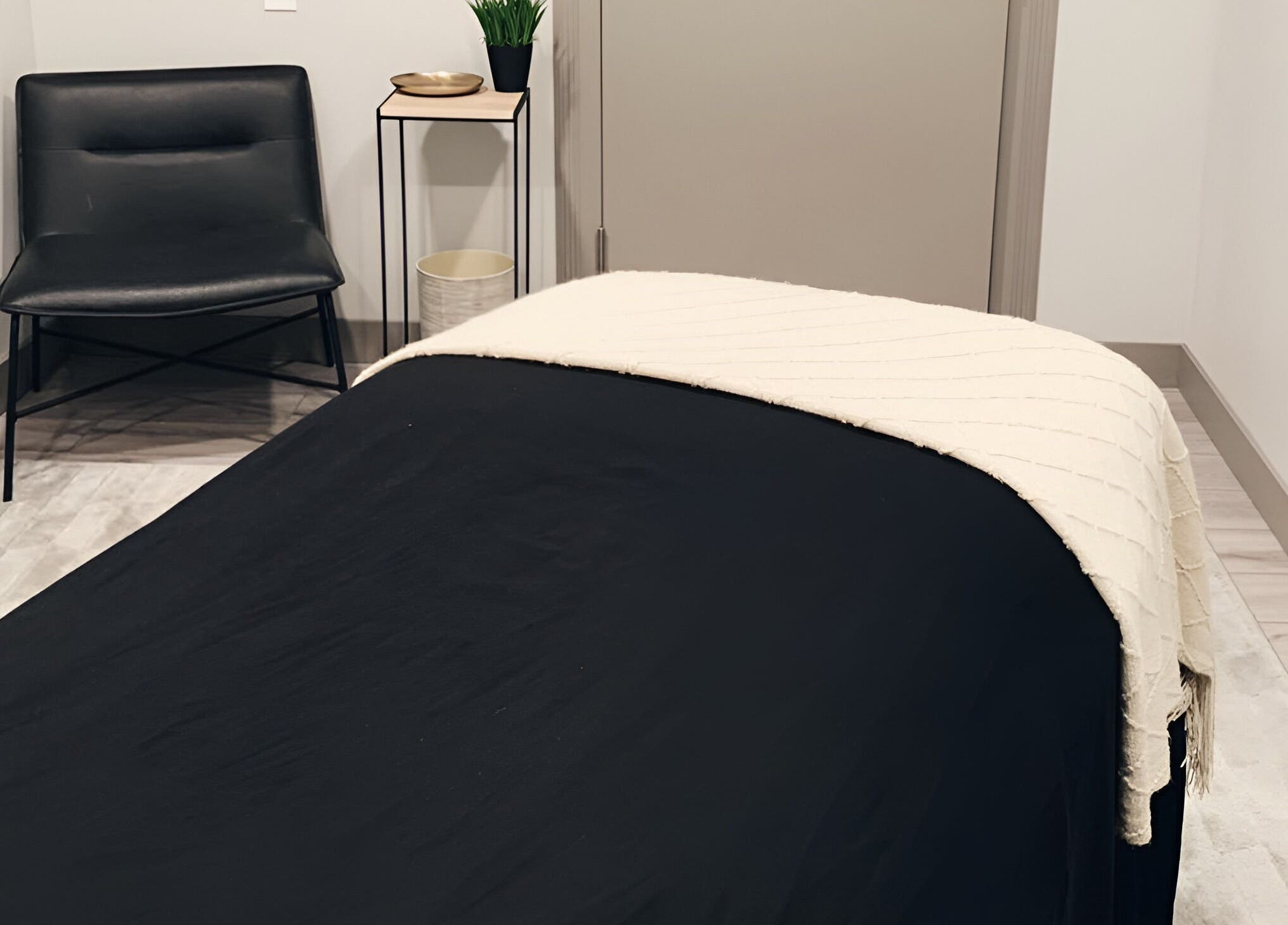Cozy massage room at The Valley Day Spa and Salon in Pender, Nebraska, US, featuring a sleek black chair.