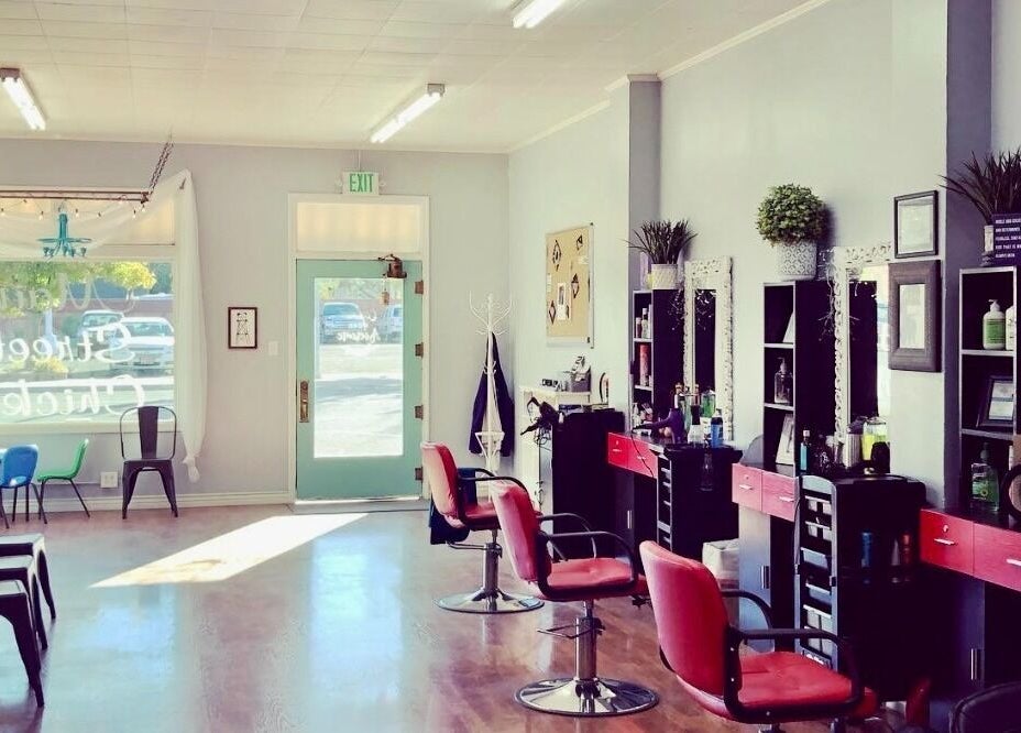 Elegant interior of Hip2BU salon in Kimberly, Idaho, US, featuring stylish chairs and mirrors.