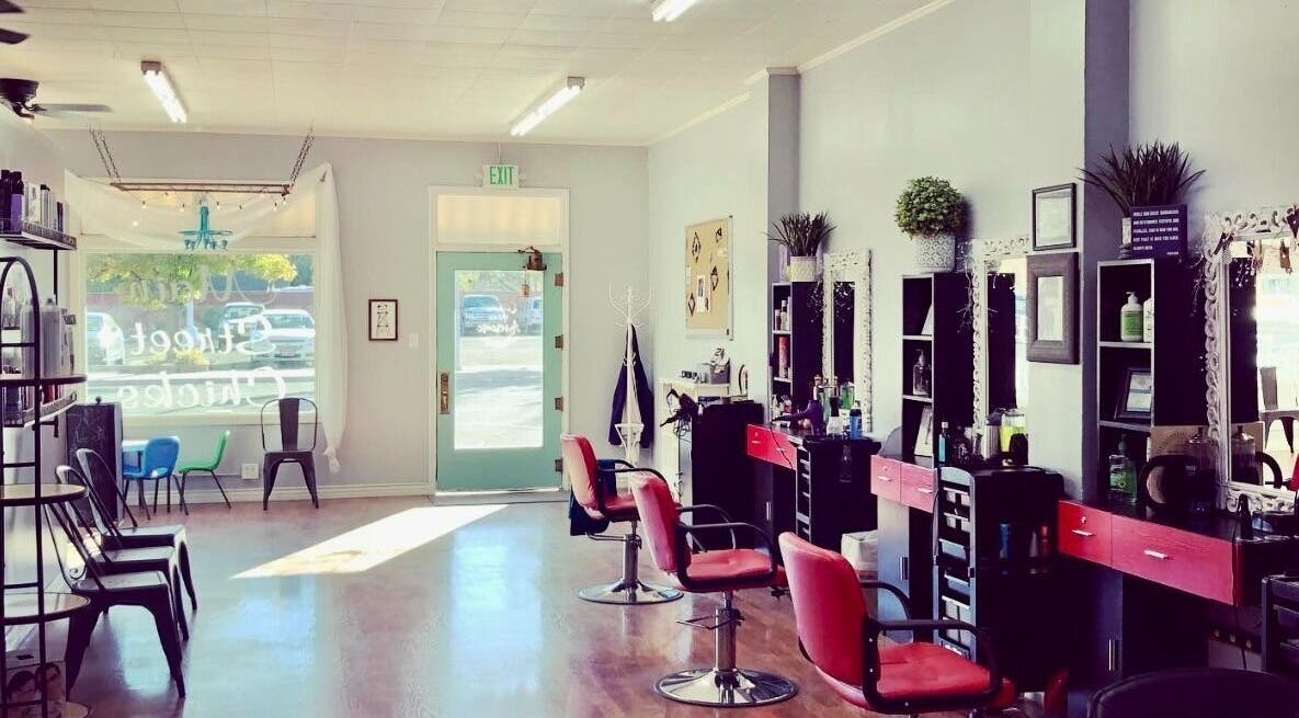 Elegant interior of Hip2BU salon in Kimberly, Idaho, US, featuring stylish chairs and mirrors.
