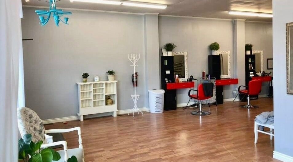 Elegant salon interior at Hip2BU, Kimberly, Idaho, US, featuring chic red chairs and tasteful decor.