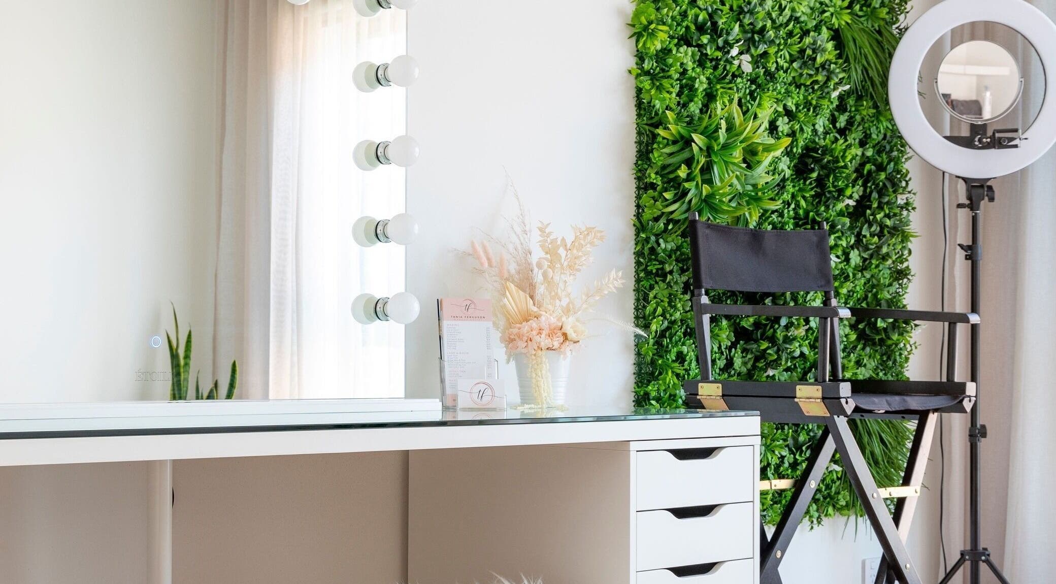 Elegant makeup station at Makeup by Tania Ferguson, Armstrong Creek, Victoria, AU with green wall and ring light.