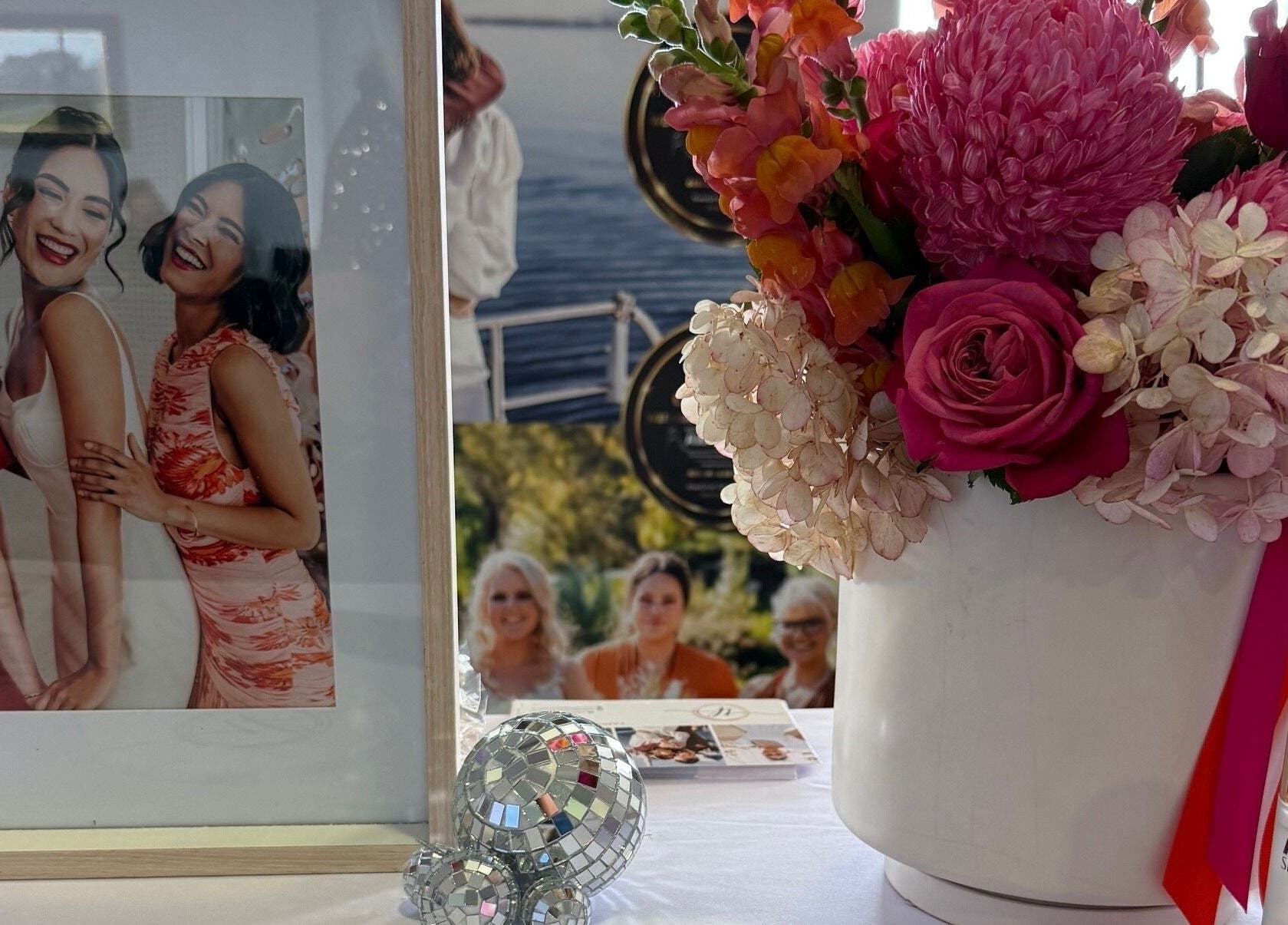 Floral arrangement beside photos at Makeup by Tania Ferguson, Armstrong Creek, Victoria, AU.