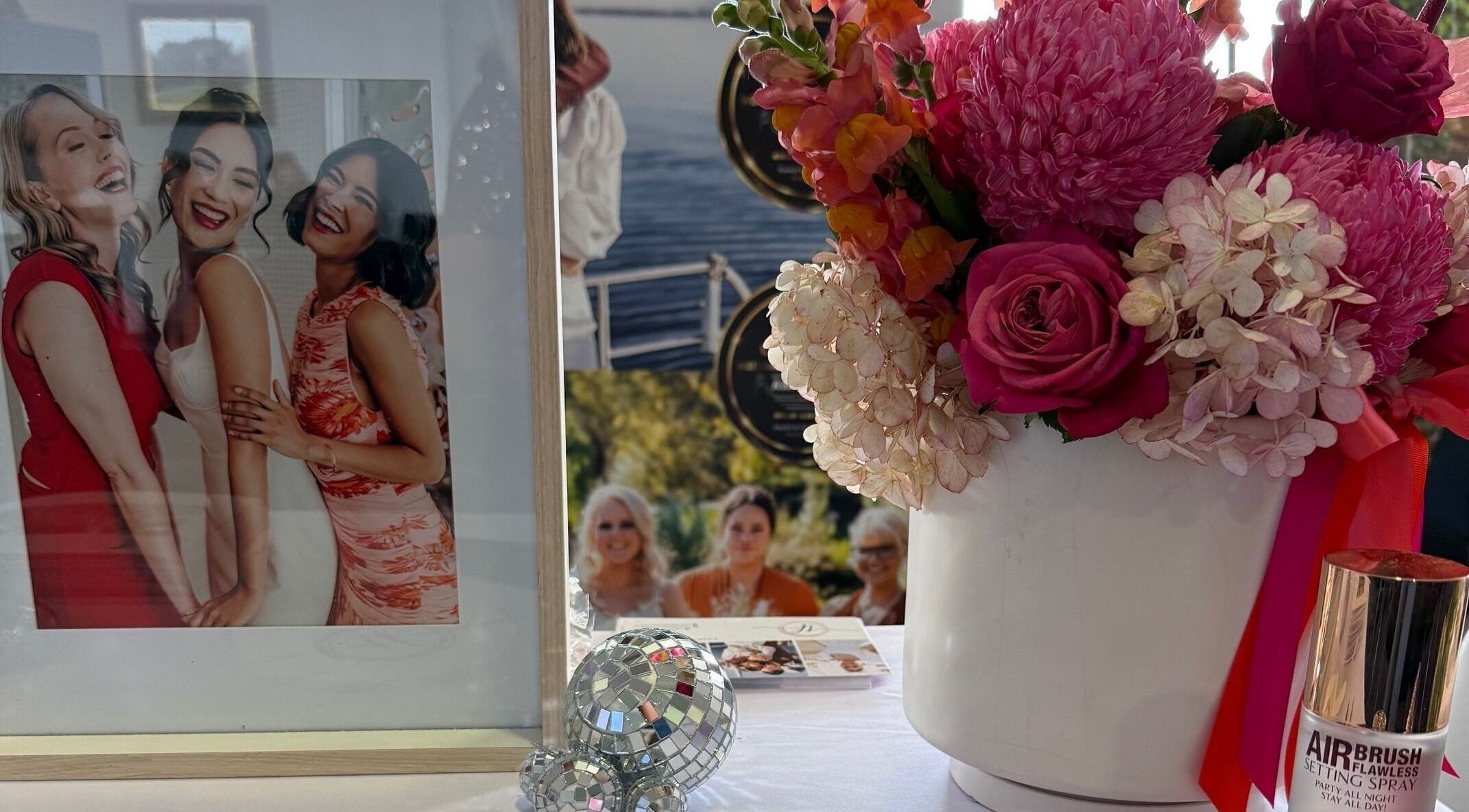 Floral arrangement beside photos at Makeup by Tania Ferguson, Armstrong Creek, Victoria, AU.