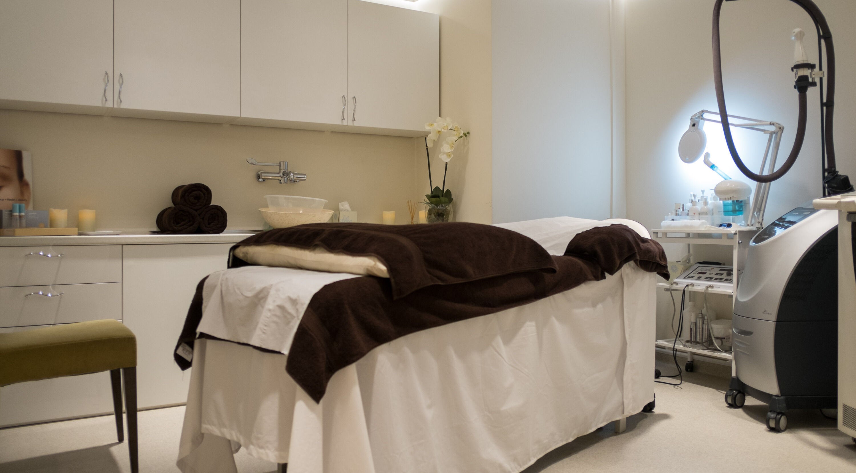 Serene treatment room at Sigma Skin Clinic, London, England, GB, with cozy bed and modern equipment.