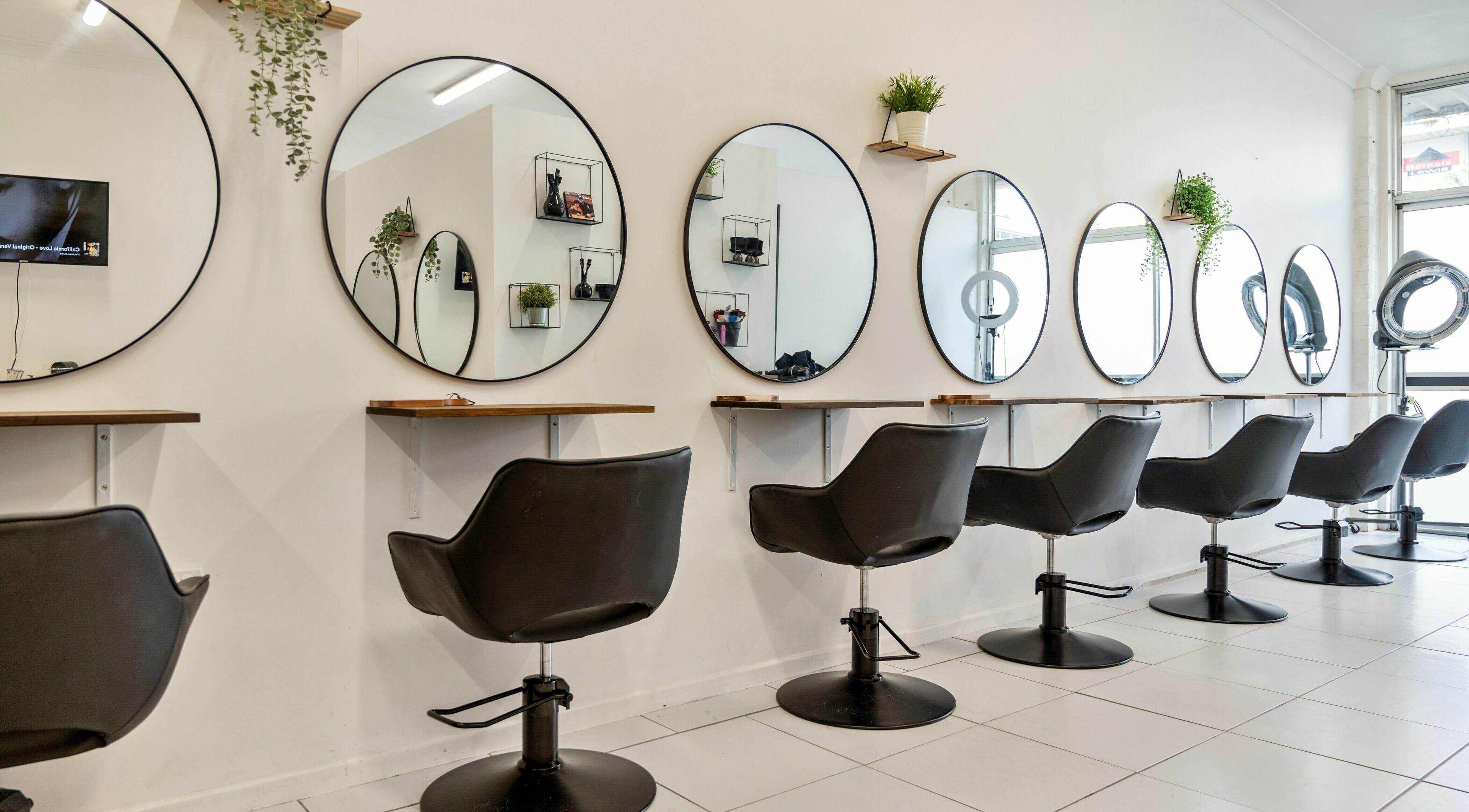 Modern chic salon interior at Becz Hair Lounge, Beenleigh, Queensland, AU with stylish chairs and mirrors.