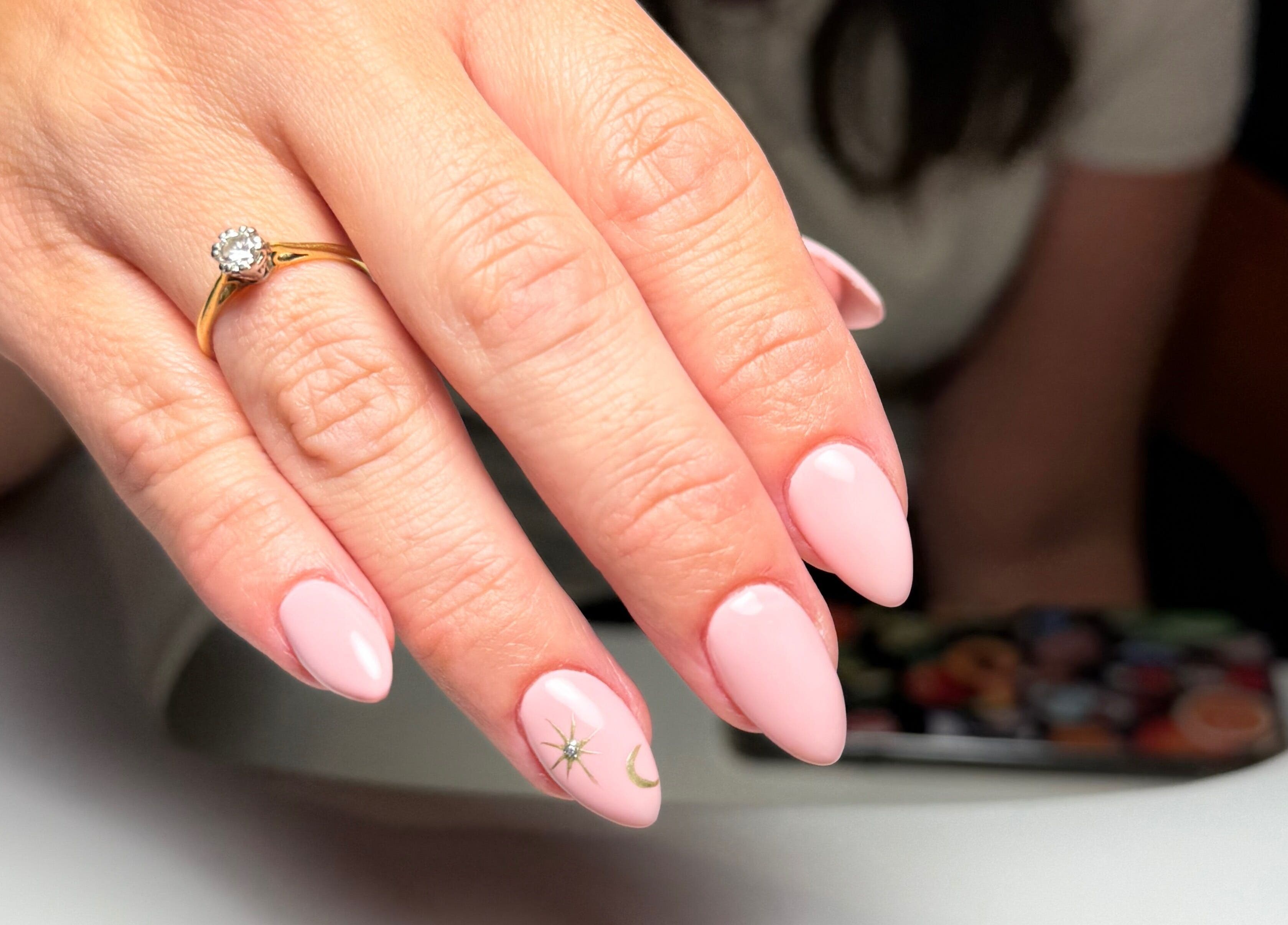 Polished nails with pink finish and design at Ruby Rae Nails, Walton-on-the-Naze, England, GB.