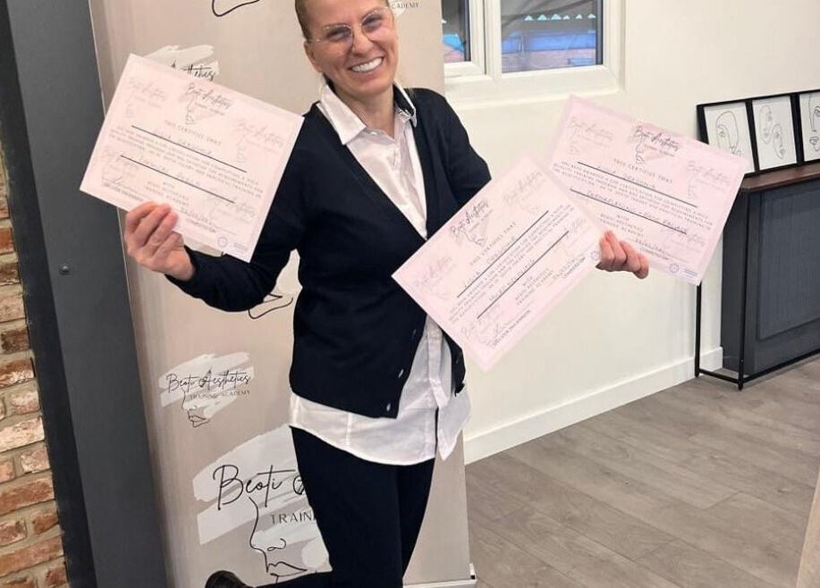 Smiling individual showcasing certificates at Beoti Aesthetics in Ashton-under-lyne, England, GB.