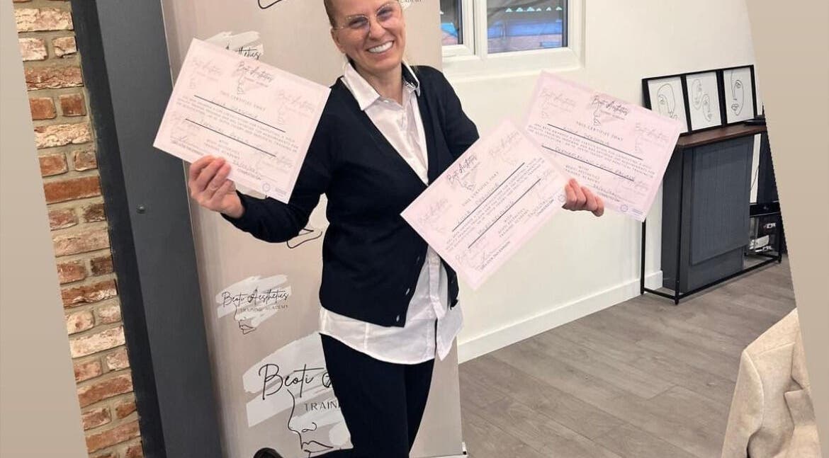 Smiling individual showcasing certificates at Beoti Aesthetics in Ashton-under-lyne, England, GB.