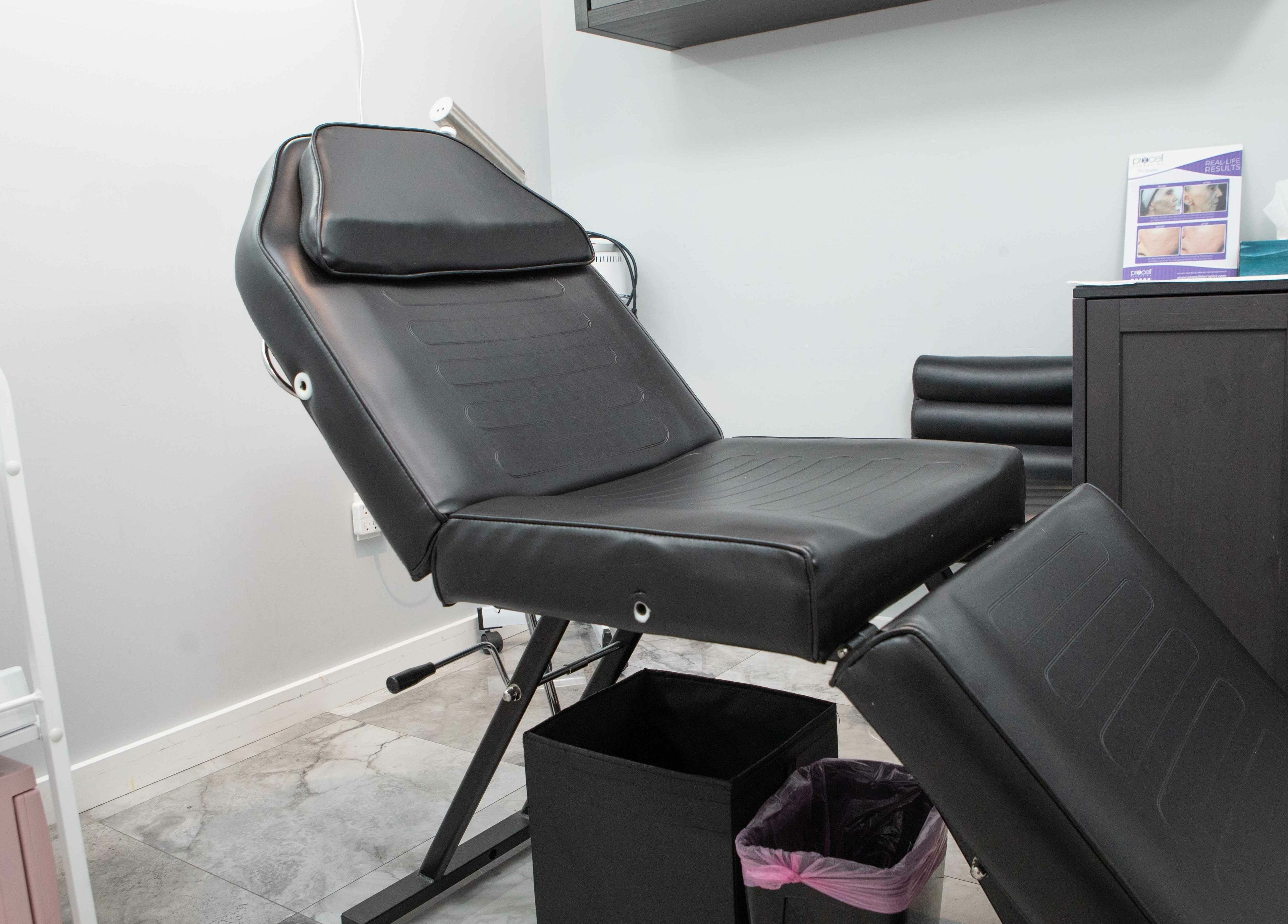 Modern treatment room at Elva Medical Aesthetics, Stoney Creek, Hamilton, Ontario, CA with sleek black chair.
