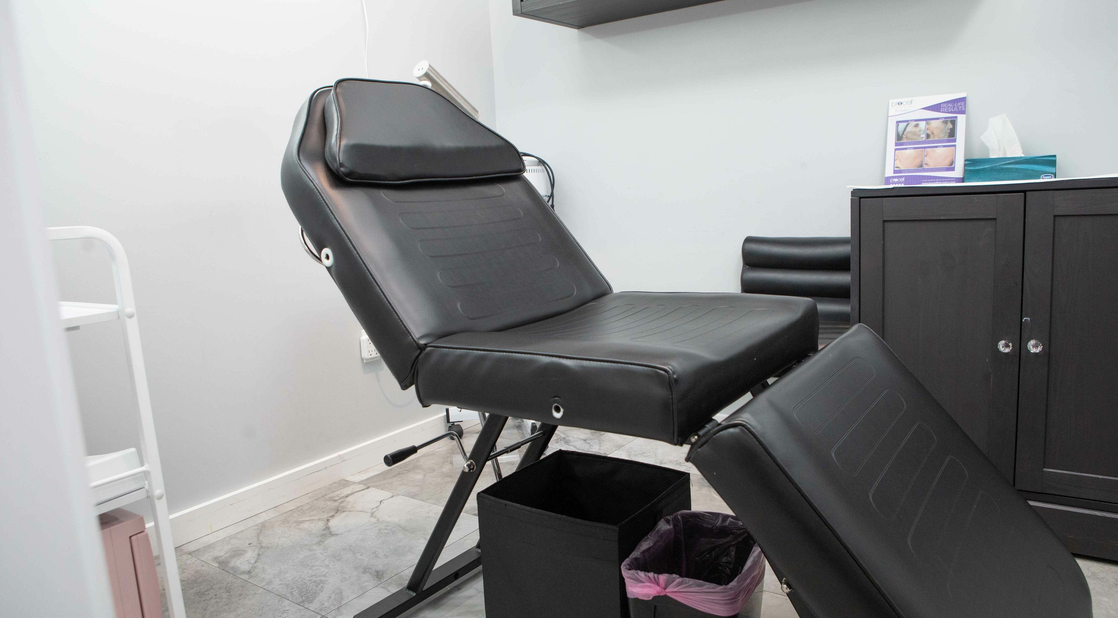 Modern treatment room at Elva Medical Aesthetics, Stoney Creek, Hamilton, Ontario, CA with sleek black chair.