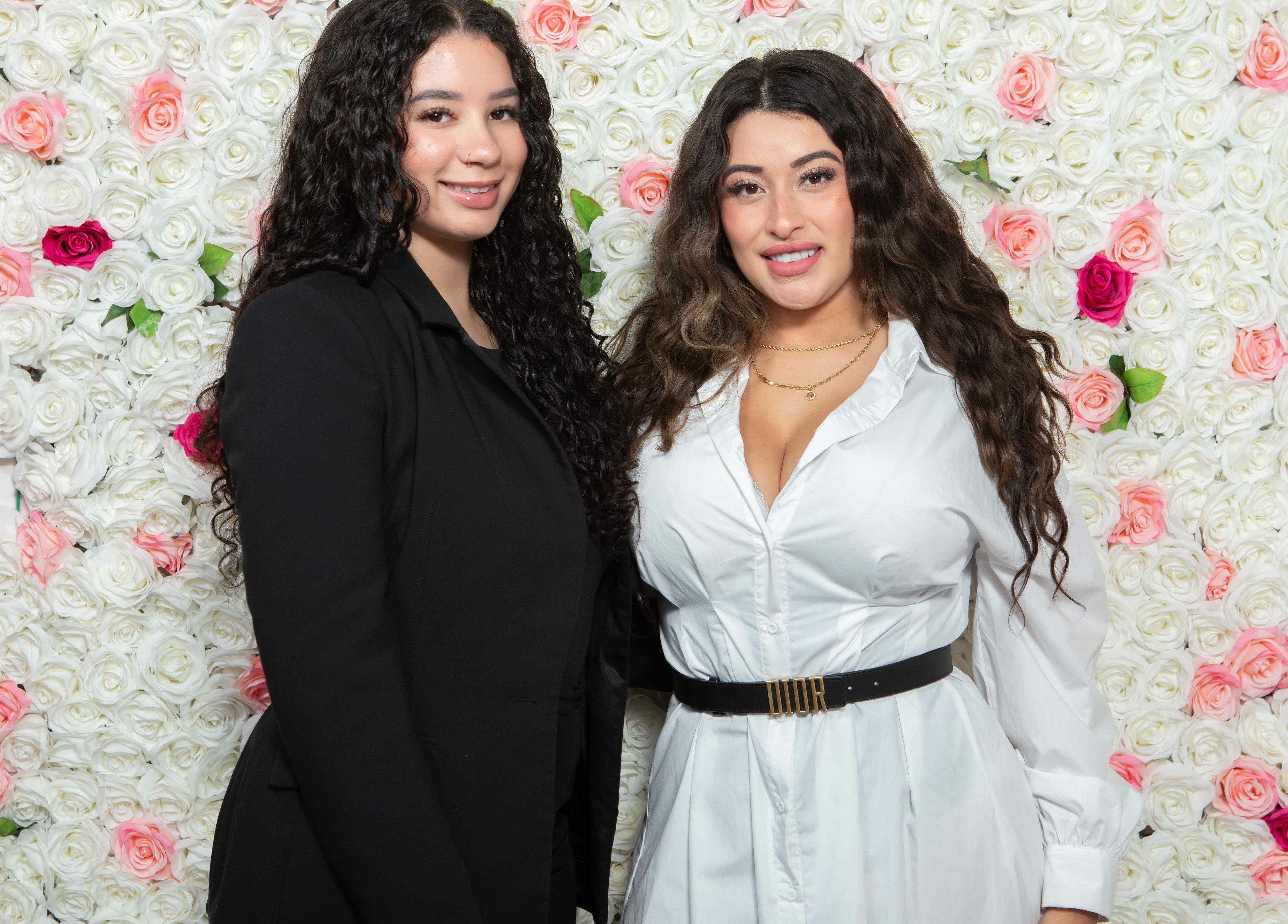 Staff at Elva Medical Aesthetics, Stoney Creek, in front of a floral wall in Hamilton, Ontario, CA.