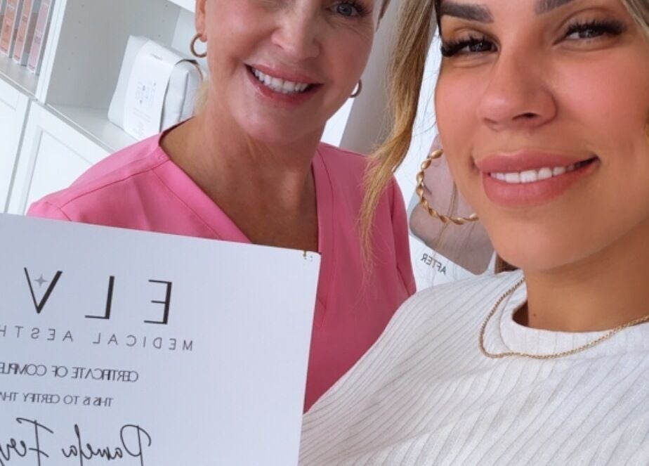 Happy Elva Medical Aesthetics clients holding a certificate at Caledonia, Ontario, CA.