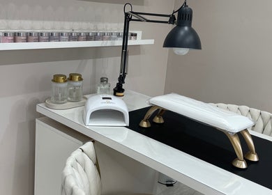 Modern nail station at 11:11 Studios, Leicester, England, GB features lamp and organized shelves.