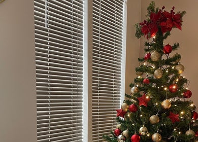 Christmas tree adorned with red and gold ornaments at 11:11 Studios, Leicester, England, GB.