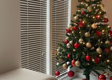 A Christmas tree with red and gold ornaments at 11:11 Studios, Leicester, England, GB.