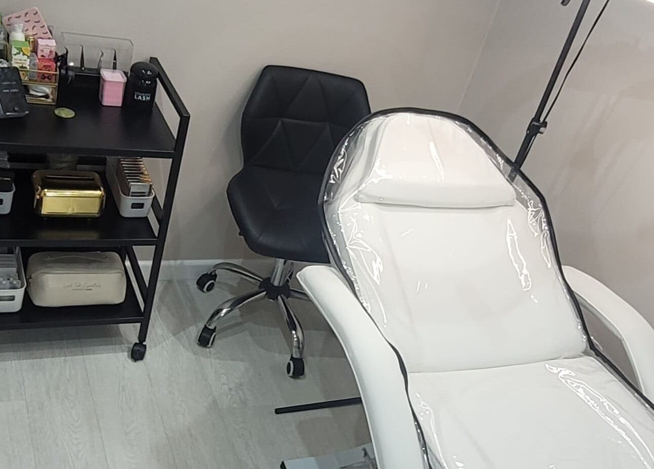 11:11 Studios in Leicester, England, GB features a modern treatment chair and organized beauty supplies.