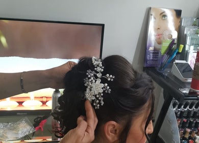 Stylist perfecting bridal hair with pearl accessory at Beauty Home Spa in Saskatoon, Saskatchewan, CA.