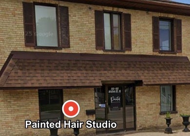 Exterior of Painted Hair Studio in Kitchener, Ontario, CA, showcasing a rustic brick facade.