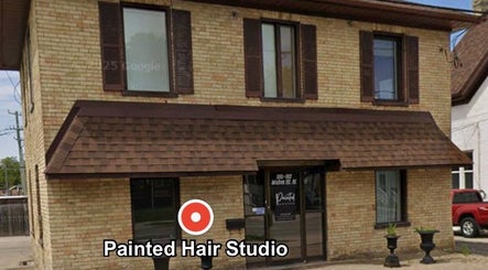 Exterior of Painted Hair Studio in Kitchener, Ontario, CA, showcasing a rustic brick facade.
