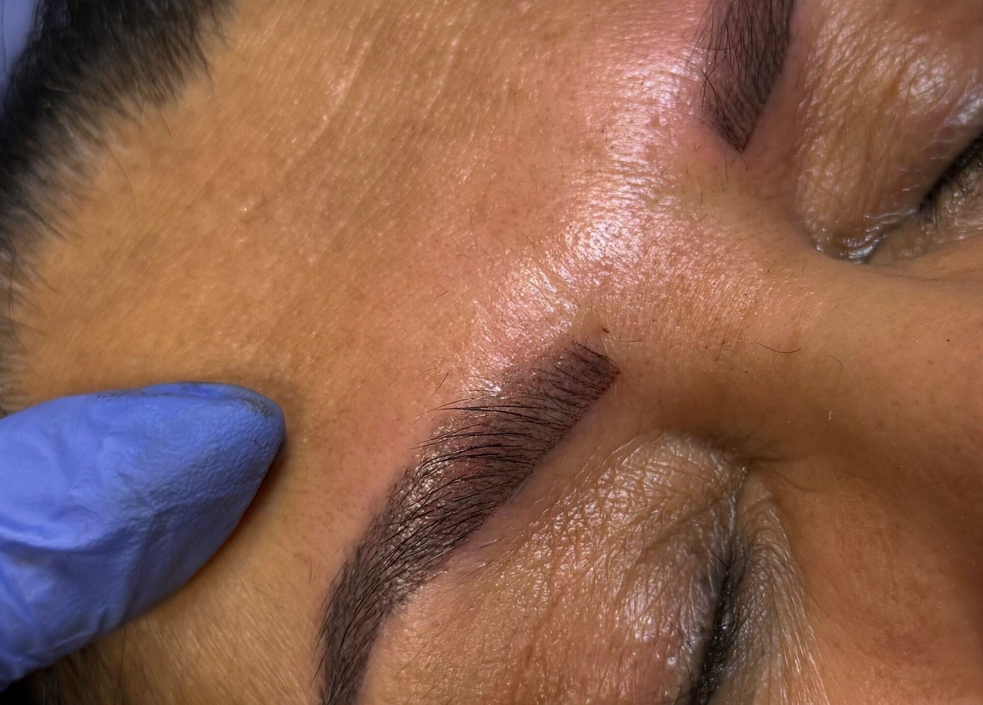 Close-up of eyebrow microblading at FNBC Salon in Leicester, England, GB, showing precise brow shaping.