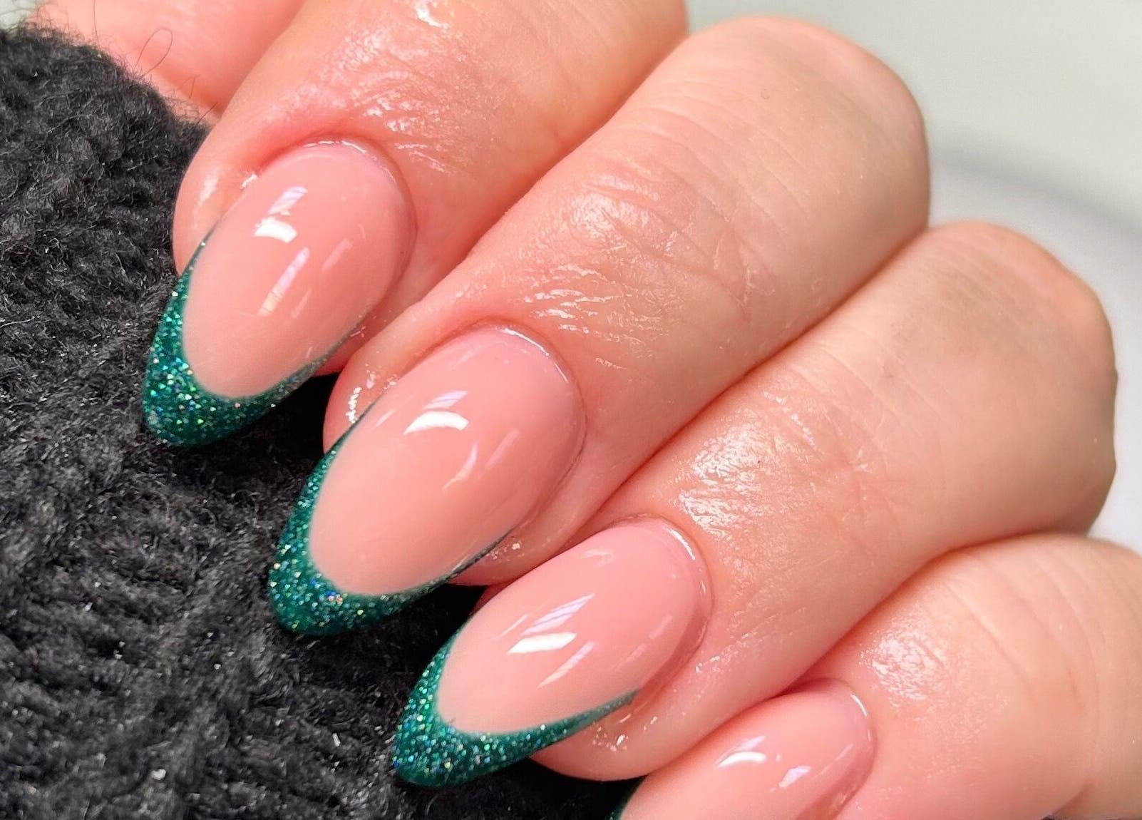 Elegant green glitter French nails at FNBC Salon, Leicester, England, GB. Perfect blend of style and sophistication.