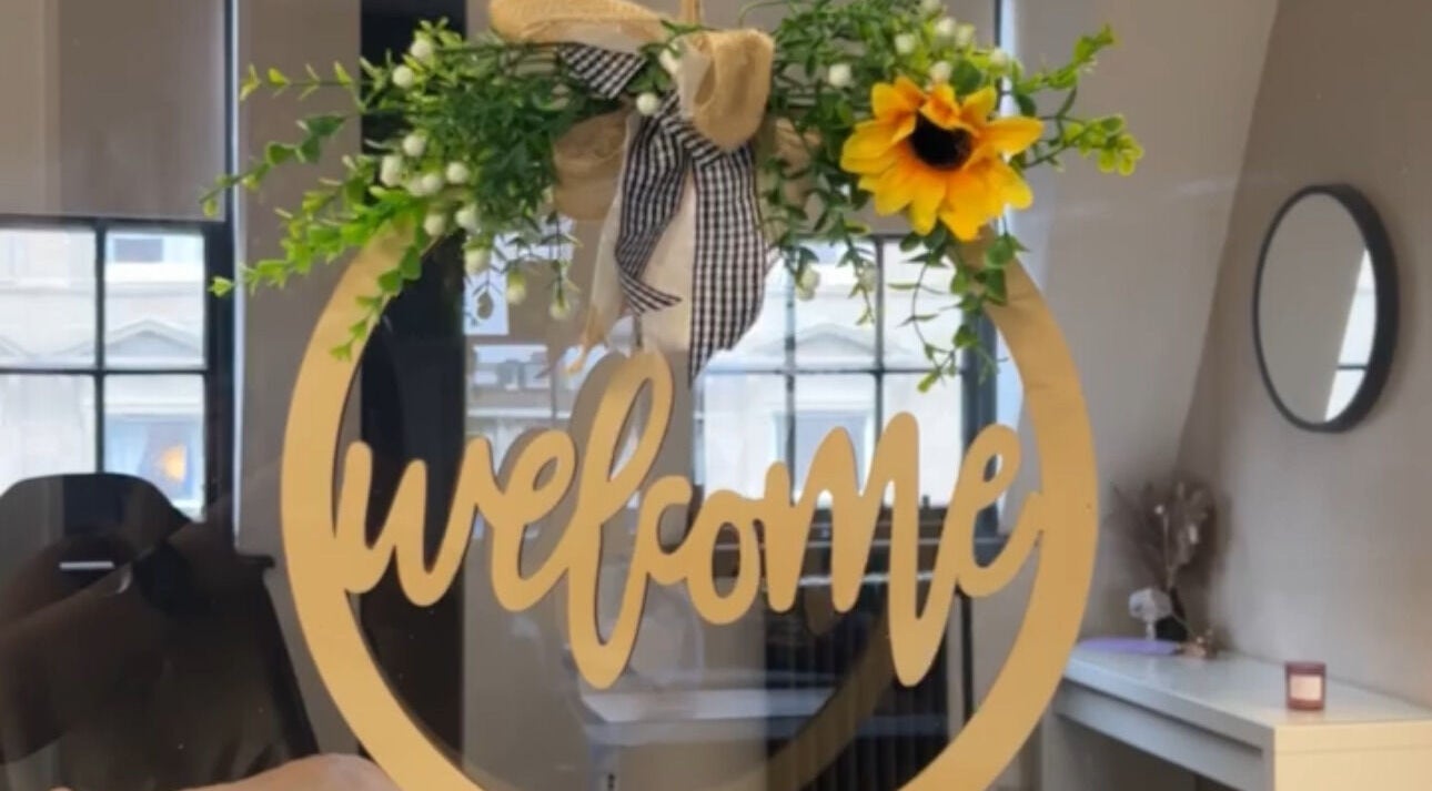 Welcome sign with floral decor at Aleceia Beauty, Dundee, Scotland, GB.