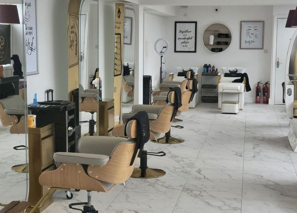 Spacious interior of La Bella Aesthetic Clinic in Salford, England, GB featuring salon chairs and elegant decor.