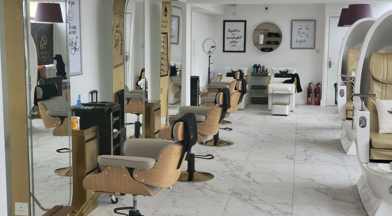 Spacious interior of La Bella Aesthetic Clinic in Salford, England, GB featuring salon chairs and elegant decor.