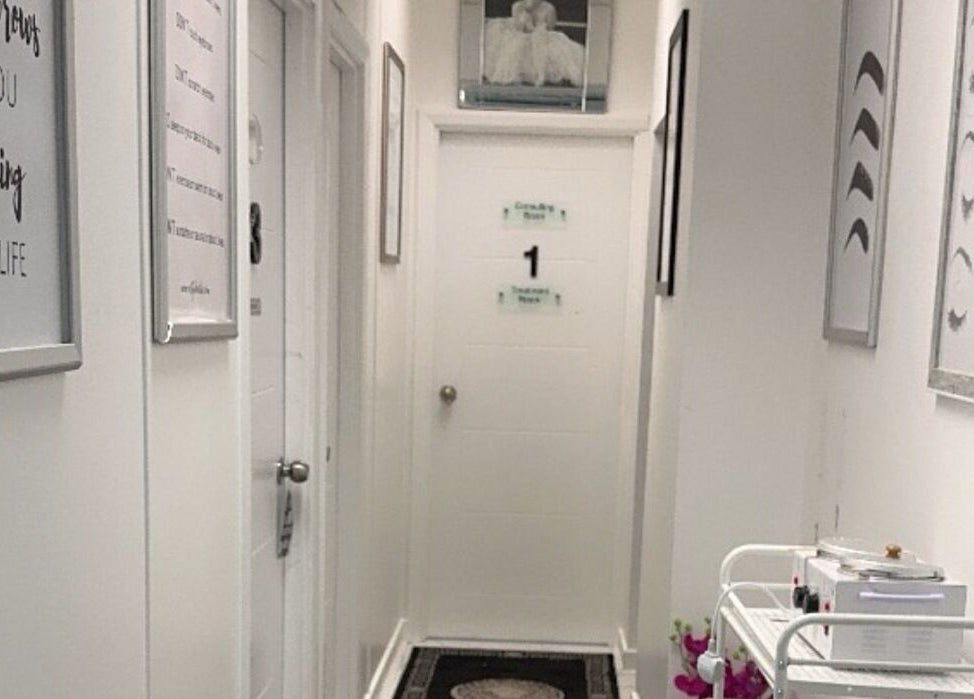 Hallway at La Bella Aesthetic Clinic, Salford, England, featuring welcoming decor and signage.