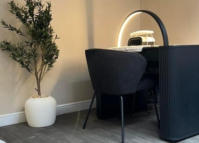 Modern aesthetics workspace at DermaLush Aesthetics, Normanton, England, GB, featuring sleek furniture and greenery.