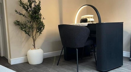 Modern aesthetics workspace at DermaLush Aesthetics, Normanton, England, GB, featuring sleek furniture and greenery.