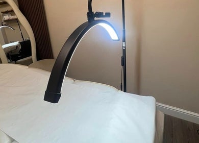 Cozy treatment room at DermaLush Aesthetics, Normanton, England, GB, featuring a treatment bed and soft lighting.
