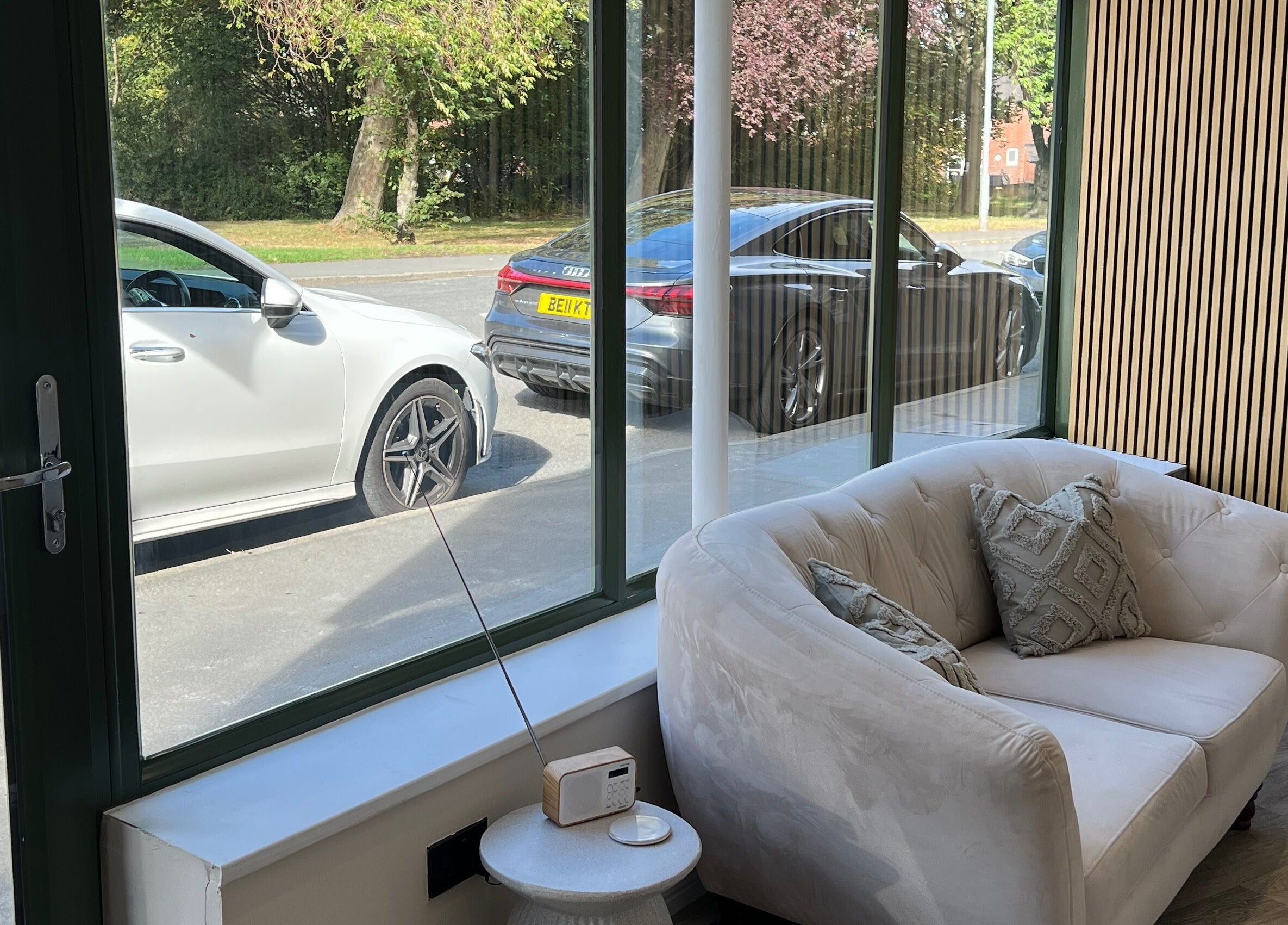 Comfy seating by the window at DermaLush Aesthetics, Normanton, with outdoor view and serene ambiance.