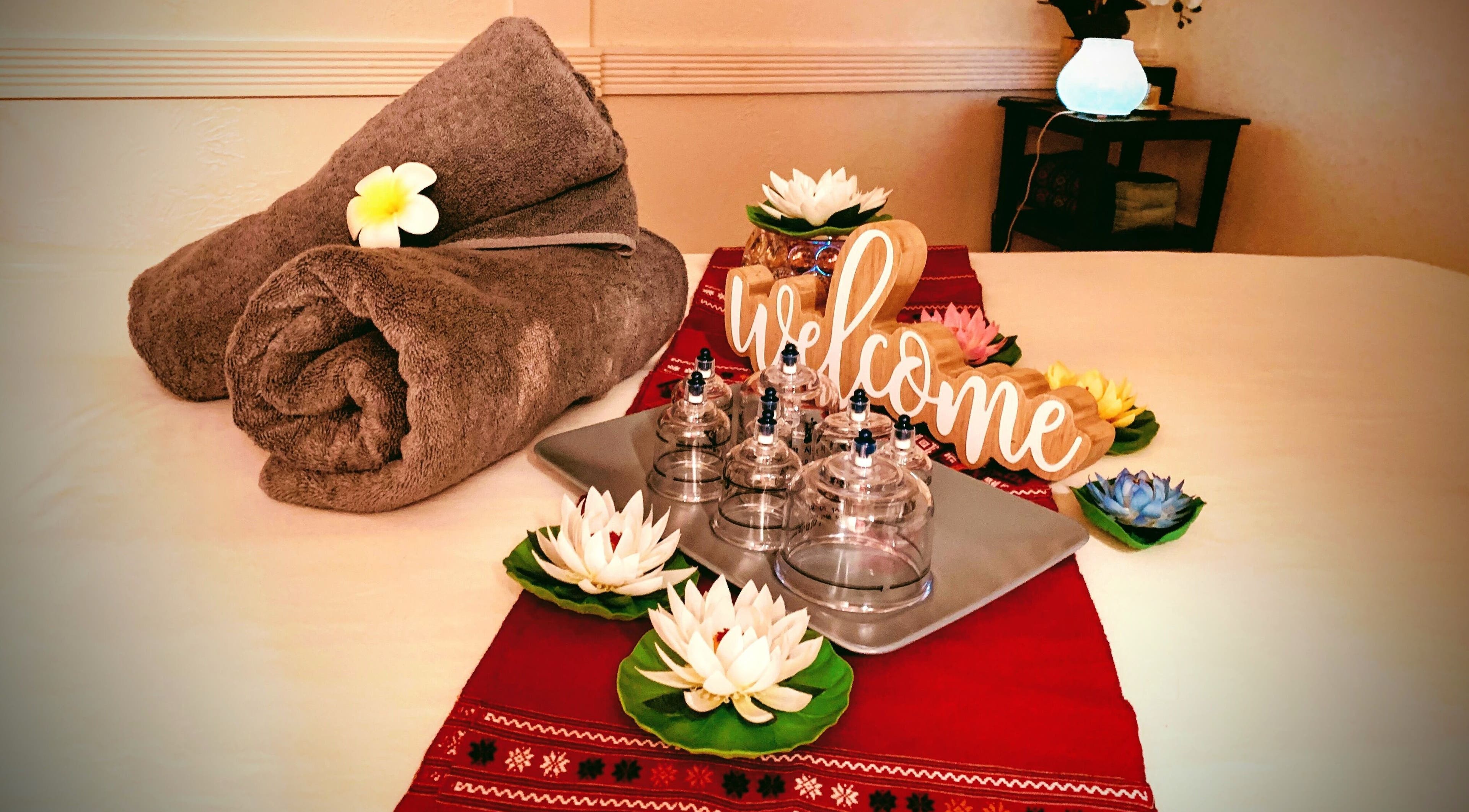 Tranquil spa setting at Siri Thai Massage and Bodywork in Sacramento, California, US, with towels and welcome sign.