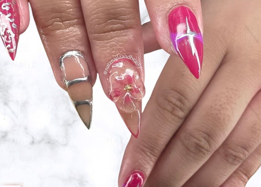 Intricate nail art at Natz Nailz and Beauty, Parkwood, Queensland, AU showcases vibrant pink and metallic designs.